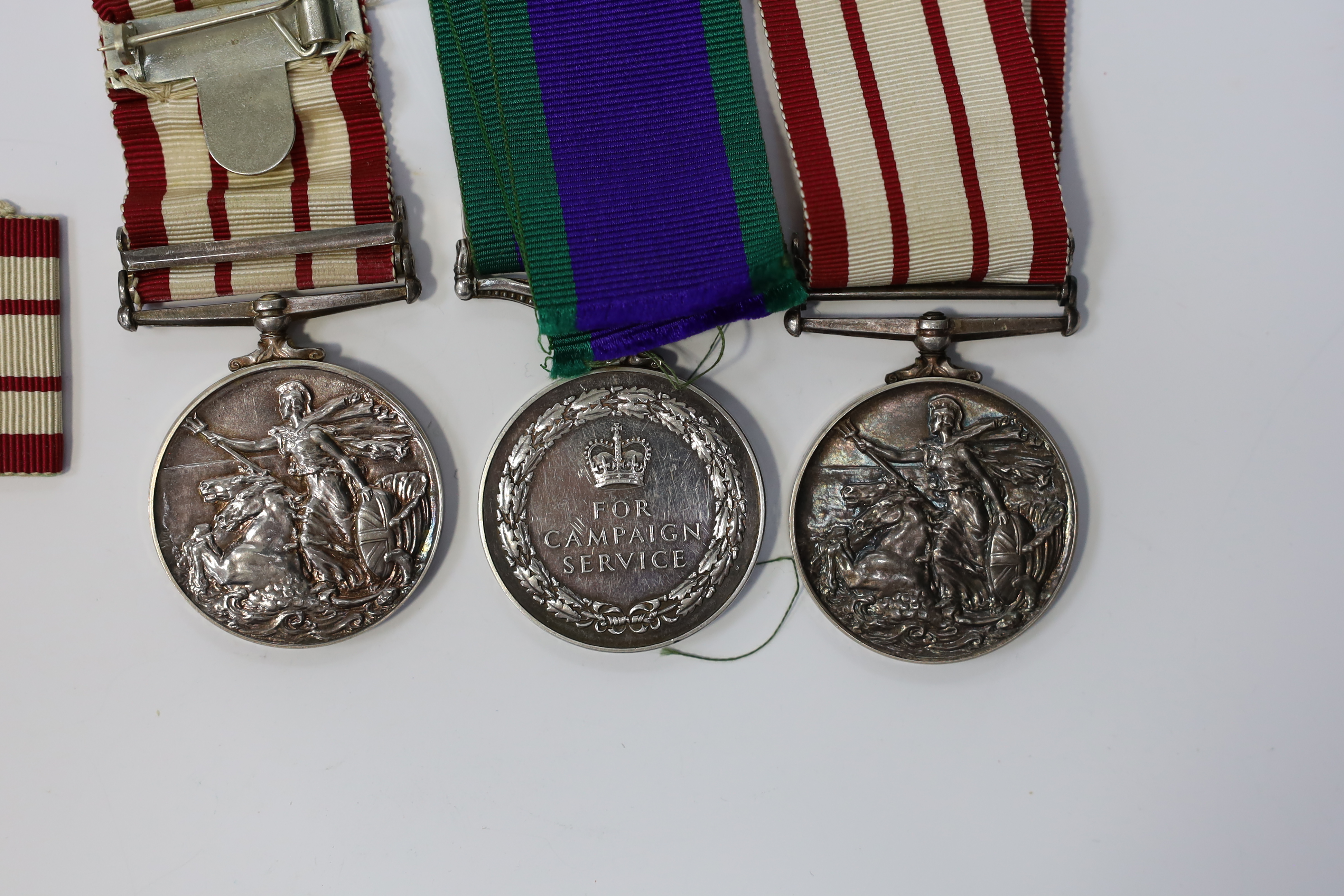 Three ERII Royal Navy medals; a Campaign Service Medal with a bar for Radfan awarded to J. Rush R.E.A.2 R.N., A Naval General Service Medal with a bar for the near East awarded to P/SKX J-C. Shaw M.(E.)1. R.N., plus a se